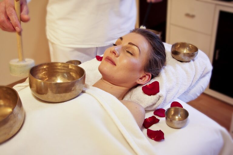 Woman receiving wholistic singing bowls treatment