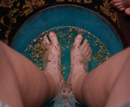 Feet soaking in herbal foot soak