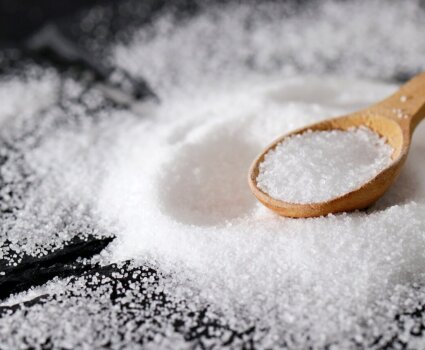 A wooden teaspoon in a pile of salt